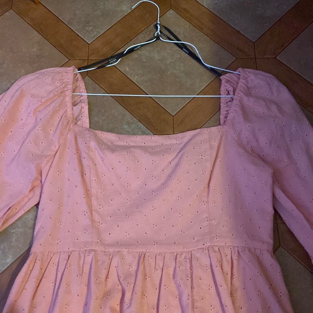 A knee length pink midi dress